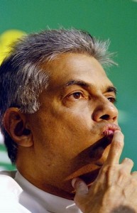 Opposition leader Ranil Wickramasinghe listens to journalists during a National Council coalition party news conference in Colombo